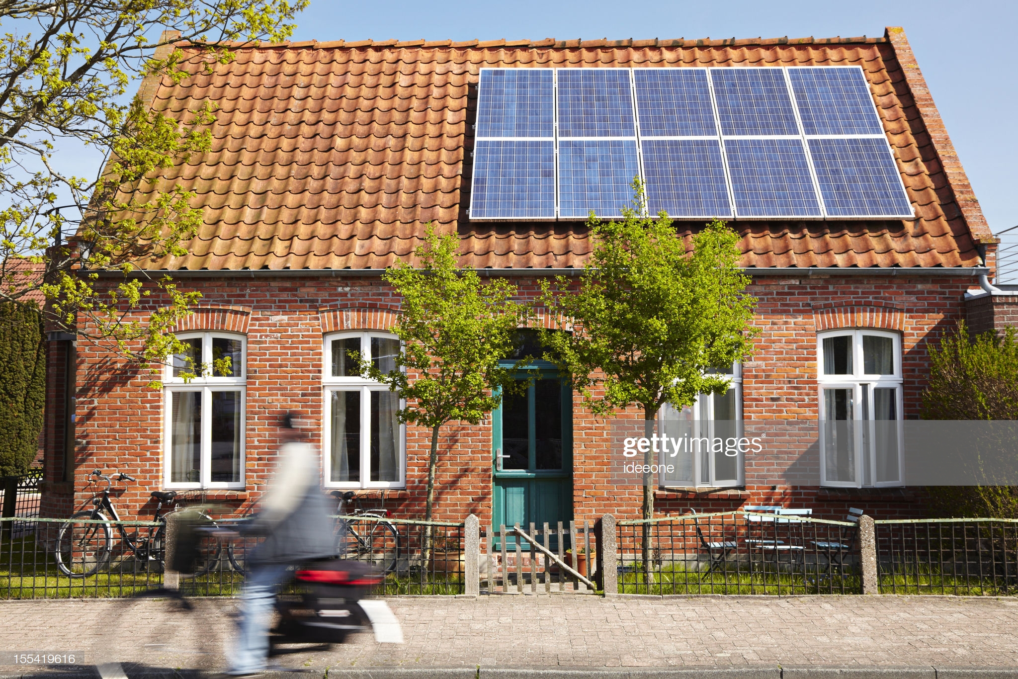 Little Traditional northern Brick house with photovoltaic technology on the roof